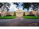 The historic brick building features manicured lawns, mature trees, and well-maintained grounds at 4658 Sugar Plum Ln, Davidson, NC 28036