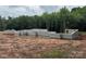 This shows a foundation on a wooded homesite, ready for framing the new home at 4658 Sugar Plum Ln, Davidson, NC 28036