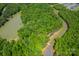 Aerial view of a wooded lot next to a pond at 1052 Ventosa Dr, Denver, NC 28037