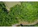 Aerial lot view; wooded lot near pond and road at 1052 Ventosa Dr, Denver, NC 28037