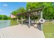 Peaceful lake dock with benches and American flag at 1052 Ventosa Dr, Denver, NC 28037