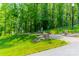 Wooded lot with a gravel path and rock features at 1052 Ventosa Dr, Denver, NC 28037