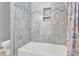 Bathroom with shower/tub combo, gray tile, and updated vanity at 6436 Mallard View Ln, Charlotte, NC 28269