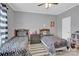 Two twin beds with patterned bedding and a ceiling fan at 6436 Mallard View Ln, Charlotte, NC 28269