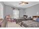 Two twin beds with patterned bedding and a ceiling fan at 6436 Mallard View Ln, Charlotte, NC 28269