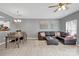 Dining area with gray walls, wooden table, and leather sectional sofa at 6436 Mallard View Ln, Charlotte, NC 28269