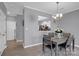 Dining room with gray walls, wooden table, and chandelier at 6436 Mallard View Ln, Charlotte, NC 28269