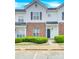 Two story brick and white townhome with landscaping and parking at 6436 Mallard View Ln, Charlotte, NC 28269