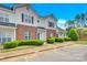 Two story brick and white townhome with landscaping and parking at 6436 Mallard View Ln, Charlotte, NC 28269