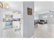 Open concept kitchen with stainless steel appliances, white cabinets, and view into living room at 6436 Mallard View Ln, Charlotte, NC 28269