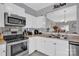 White kitchen with stainless steel appliances and breakfast bar at 6436 Mallard View Ln, Charlotte, NC 28269