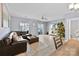 Spacious living room with gray walls, dark leather sectional sofa, and Christmas tree at 6436 Mallard View Ln, Charlotte, NC 28269