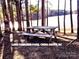 Peaceful lakeside picnic area with wooden table and benches at 204 Kimball Rd, China Grove, NC 28023