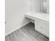 Bathroom with white vanity, gray floors, large mirror, and natural light from doorway at 6003 Treetop Ct, Charlotte, NC 28212