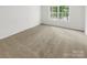 Bedroom featuring carpeted floor, window, and neutral color palette at 6003 Treetop Ct, Charlotte, NC 28212
