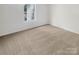 Bright bedroom with a window and neutral carpet at 6003 Treetop Ct, Charlotte, NC 28212