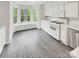 Bright kitchen featuring a bay window, modern appliances, sleek countertops, and stylish gray flooring at 6003 Treetop Ct, Charlotte, NC 28212