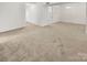 Large living room with neutral carpeting, open layout, and seamless flow into the dining and kitchen areas at 6003 Treetop Ct, Charlotte, NC 28212