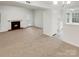 Inviting living room with fireplace, and an open layout connecting it to the kitchen, with an outside door at 6003 Treetop Ct, Charlotte, NC 28212
