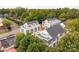 An aerial view shows modern townhomes surrounded by lush trees and the Charlotte skyline at 1409 Collier Walk Aly # Csw0104, Charlotte, NC 28205