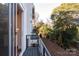 Balcony with black metal railings and view to the outside, looking toward trees and the backyard at 1409 Collier Walk Aly # Csw0104, Charlotte, NC 28205