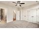 Bedroom with three closets, neutral colors, ceiling fan, and doorways to bathroom and hall at 1409 Collier Walk Aly # Csw0104, Charlotte, NC 28205