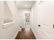 A hallway leading to a bedroom and staircase with white molding and hardwood floors at 1409 Collier Walk Aly # Csw0104, Charlotte, NC 28205