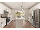 Bright kitchen with stainless steel appliances, center island and sliding glass doors to the outside at 1409 Collier Walk Aly # Csw0104, Charlotte, NC 28205