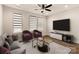 Living room with hardwood floors, recessed lighting, ceiling fan and large flat screen TV at 1409 Collier Walk Aly # Csw0104, Charlotte, NC 28205