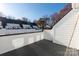 Expansive rooftop deck with gray plank flooring and bright sunlight at 1409 Collier Walk Aly # Csw0104, Charlotte, NC 28205