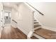 Well-maintained staircase with hardwood floors and white-painted trim leading upstairs at 1409 Collier Walk Aly # Csw0104, Charlotte, NC 28205