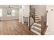 An ornate staircase leading upstairs with hardwood floors and an open railing concept at 1409 Collier Walk Aly # Csw0104, Charlotte, NC 28205