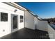 This outdoor deck has gray floor boards and white vertical plank railing with a glass door for entry at 1411 Collier Walk Aly # Csw0105, Charlotte, NC 28205