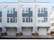 Row of three-story townhomes feature individual garages and modern gray and white plank design at 1411 Collier Walk Aly # Csw0105, Charlotte, NC 28205