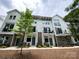 Three-story townhomes offer modern gray and white plank design with black balcony railings at 1411 Collier Walk Aly # Csw0105, Charlotte, NC 28205