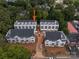 An aerial view of modern townhomes featuring dark roofs and neutral siding in a well-planned community at 1413 Collier Walk Aly # Csw0106, Charlotte, NC 28205