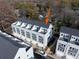 An aerial view of modern townhomes with a dark roof, neutral siding and balconies at 1413 Collier Walk Aly # Csw0106, Charlotte, NC 28205