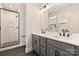 Modern bathroom with double sink vanity, black fixtures, and glass-enclosed shower at 1413 Collier Walk Aly # Csw0106, Charlotte, NC 28205