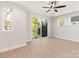 Bedroom with ceiling fan, large sliding glass door to private balcony, and wood grain floors at 1413 Collier Walk Aly # Csw0106, Charlotte, NC 28205