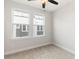 Bedroom with neutral carpet, two windows providing natural light, and outlets at 1413 Collier Walk Aly # Csw0106, Charlotte, NC 28205