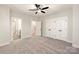 Spacious bedroom with neutral carpet, ceiling fan, and ample closet space for storage solutions at 1413 Collier Walk Aly # Csw0106, Charlotte, NC 28205