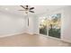 Bedroom with ceiling fan, large sliding glass door to private balcony, and wood grain floors at 1413 Collier Walk Aly # Csw0106, Charlotte, NC 28205