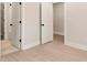 Bright bedroom featuring neutral walls, light wood-look flooring, and minimalist trimwork for a modern, clean aesthetic at 1413 Collier Walk Aly # Csw0106, Charlotte, NC 28205