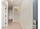 Bright entryway featuring light-colored wood flooring, white walls and trim, and a modern staircase at 1413 Collier Walk Aly # Csw0106, Charlotte, NC 28205