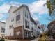 A row of modern townhomes with brick accents, neutral siding, balconies, and mature trees at 1413 Collier Walk Aly # Csw0106, Charlotte, NC 28205