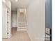 Hallway featuring stairs, a doorframe, and neutral paint at 1413 Collier Walk Aly # Csw0106, Charlotte, NC 28205