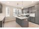 Bright kitchen features grey cabinetry, stainless appliances, white countertops and a kitchen island at 1413 Collier Walk Aly # Csw0106, Charlotte, NC 28205