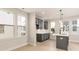 Bright kitchen with gray cabinets, white countertops and light wood-colored floors, well lit by natural light from the windows at 1413 Collier Walk Aly # Csw0106, Charlotte, NC 28205