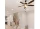 Open concept living room with ceiling fan, staircase, view of the kitchen and light wood-colored floors at 1413 Collier Walk Aly # Csw0106, Charlotte, NC 28205