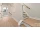 A staircase with natural wood steps, painted risers, and a light wood handrail at 1413 Collier Walk Aly # Csw0106, Charlotte, NC 28205